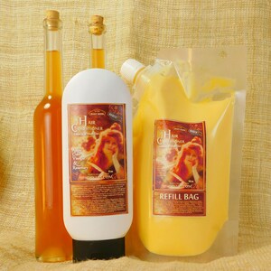 May include: Two amber glass bottles with a white bottle of hair conditioner in the center. The bottles are labeled "Hair Conditioner Leave in Wash Out Apple Cider Vinegar & Rosemary" and "Hair Conditioner Leave in Wash Out". The conditioner bottle is next to a yellow refill bag labeled "Hair Conditioner Leave in Wash Out Refill Bag".