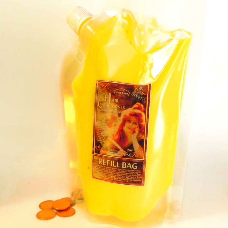 May include: A yellow refill bag of Body Brew Hair Conditioner, Leave-in Wash Out, with a vintage-style label featuring a woman with red hair. The label reads "Body Brew Hair Conditioner Leave-in Wash Out" and "REFILL BAG".