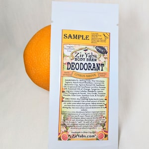 May include: A white sample packet of Zir Yab's Body Brew Deodorant in Citrus Grove scent. The packet features a photo of a citrus fruit and the text "Good-bye Stains". The ingredients and directions for use are listed on the back of the packet.