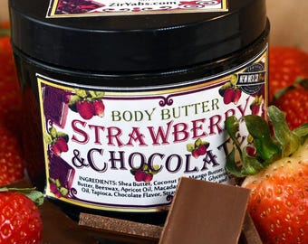 May include: A black jar of strawberry and chocolate body butter with a red and white label. The label reads "Strawberry & Chocolate Body Butter". The jar is surrounded by strawberries and chocolate squares.