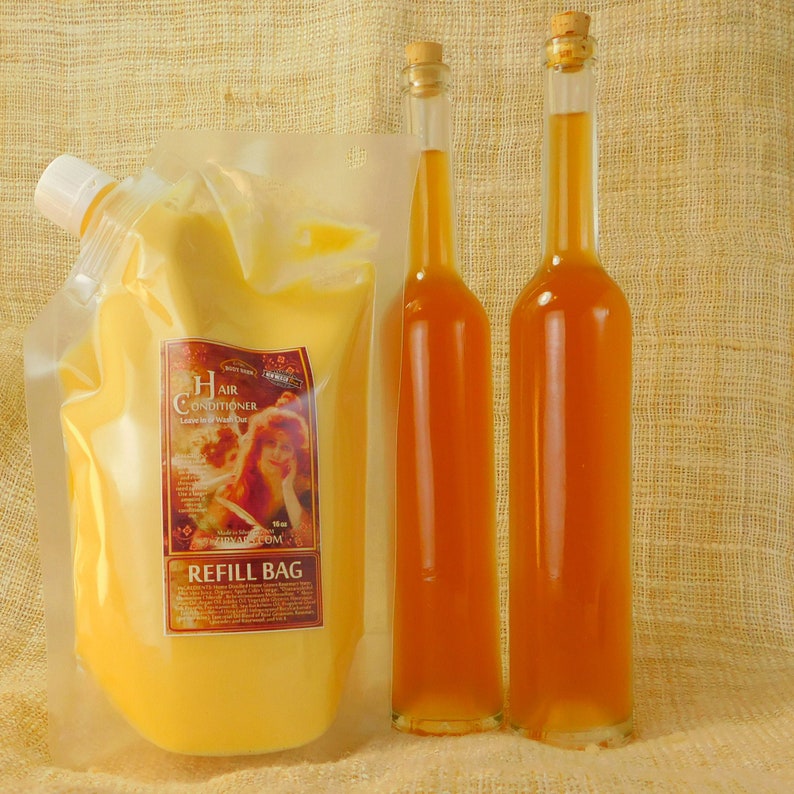 May include: A clear plastic refill bag filled with a yellow hair conditioner. The bag has a label that reads "Hair Conditioner Leave-in Wide Detangler". Two amber glass bottles with cork stoppers are in the background.