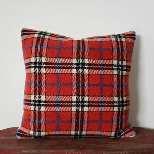 May include: Red, white, and blue plaid throw pillow with a soft, fuzzy texture.