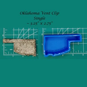 May include: A blue silicone mould shaped like the state of Oklahoma. The mould is approximately 8.3 cm by 7 cm. The mould is on a green cutting mat.