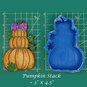 May include: A blue silicone mold for making a stack of pumpkins. The mold is 3 inches wide and 4.5 inches tall. The mold is on a green cutting mat.