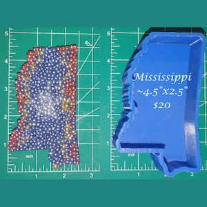 May include: A blue silicone mold of the state of Mississippi. The mold is approximately 4.5 inches by 2.5 inches. The text "Mississippi ~4.5"x2.5" $20" is printed on the mold.
