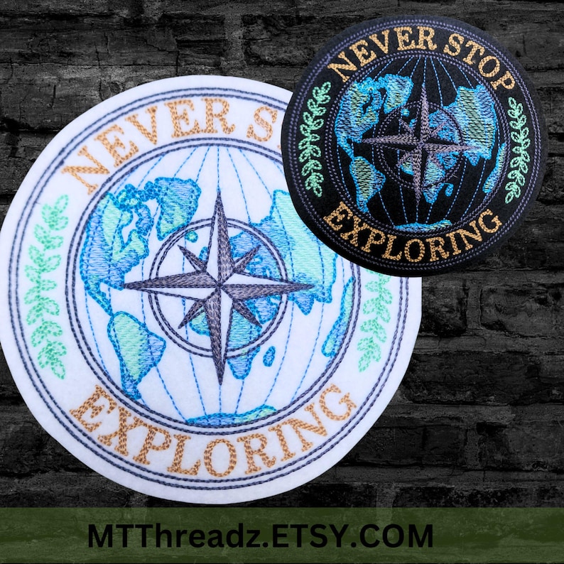 May include: Two embroidered patches with a compass and a globe design. The patches are round and have a white background with blue and green embroidery. The text "NEVER STOP EXPLORING" is embroidered in gold on both patches.