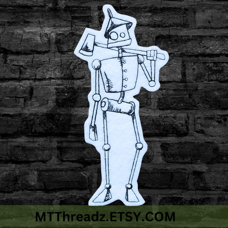 May include: A black and white line drawing of a tin man with an axe over his shoulder. The drawing is on a light blue background. The tin man is wearing a hat and has a round face with two large eyes. The drawing is on a brick wall background.