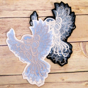 May include: Two embroidered iron-on patches featuring a stylized bird design. One patch is blue and gray, the other is white and black.