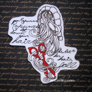 May include: A white embroidered patch with a design of Rapunzel's hair, a tower, and red scissors. The text "Rapunzel, let down your hair" and "She let her hair fall" are embroidered on the patch.