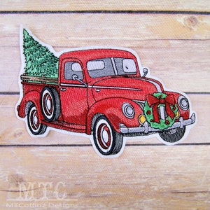 May include: Red vintage pickup truck with a Christmas tree in the bed and a wreath with a red bow on the front bumper.