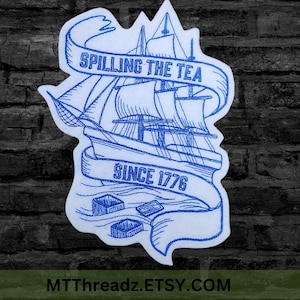 May include: Blue embroidered patch with a ship and a banner that says "Spilling the Tea Since 1776".
