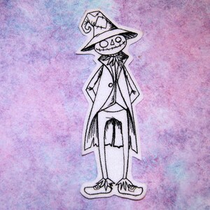 May include: A black and white line drawing of a scarecrow wearing a hat and a suit. The scarecrow is standing on a purple and blue watercolour background.