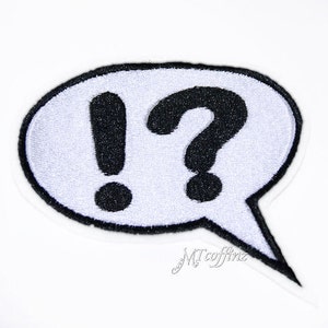 May include: White speech bubble with black embroidered exclamation point and question mark.