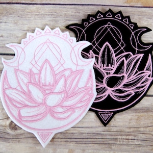May include: Two embroidered patches featuring a pink lotus flower with a crescent moon and geometric design. One patch is white with pink embroidery, the other is black with pink embroidery.