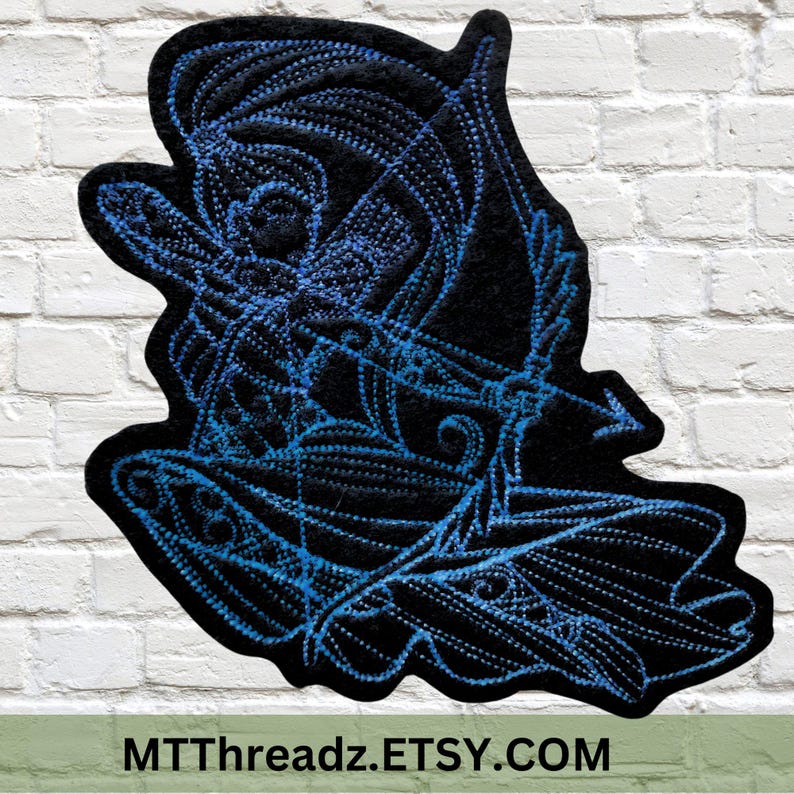 May include: A blue and black embroidered patch depicting a stylized figure with a bow and arrow. The patch is outlined in blue and has a black background. The text "MTTThreadz.ETSY.COM" is visible at the bottom of the image.