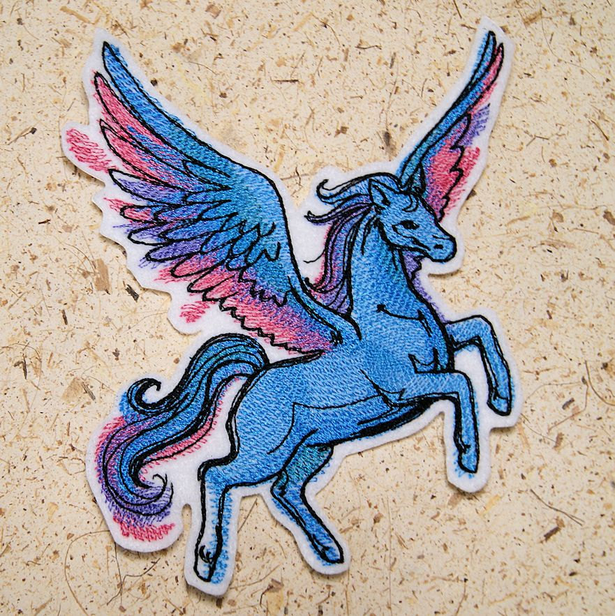 May include: Embroidered patch of a blue winged unicorn with pink and purple accents. The unicorn is standing on its hind legs with its wings spread out.