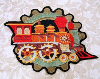May include: An embroidered iron-on patch featuring a red, orange, and brown vintage steam train with a large gear design. The train has a large smokestack and a detailed front with a sun design.
