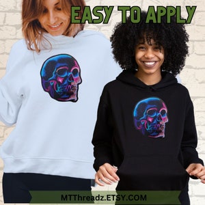 May include: Two hoodies with a colorful skull graphic. The hoodie on the left is light blue and the hoodie on the right is black. The text "EASY TO APPLY" is at the top of the image. The text "MTTThreadz.ETSY.COM" is at the bottom of the image.