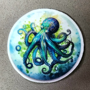 May include: A blue and green octopus with eight tentacles is depicted in a watercolor style against a white background with green and blue watercolor accents.