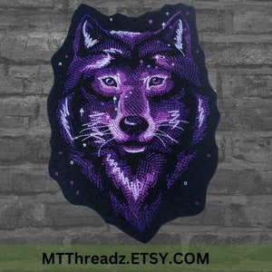 May include: Purple embroidered wolf head patch with a starry night sky background. The wolf has a white muzzle and a white outline around its eyes.