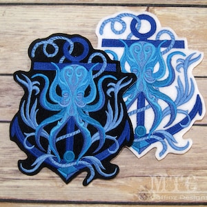 May include: A blue and black embroidered patch featuring an octopus wrapped around an anchor. The anchor is surrounded by rope and seaweed. The patch is on a wooden background.