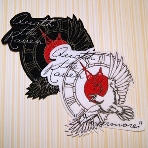 May include: Two embroidered patches with a black and white clock face, a red bird, and the text "Oath of the Raven" and "Furthermore".