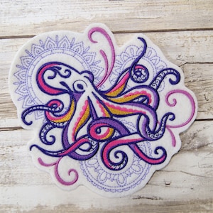 May include: Embroidered patch featuring a purple and pink octopus with yellow accents, surrounded by a purple and pink mandala design.