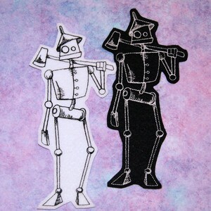 May include: Two embroidered iron man patches, one white and one black, with a silver axe in each hand.