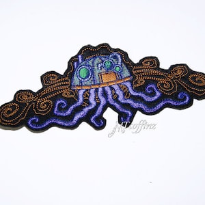 May include: An embroidered patch depicting a purple and blue octopus with a steampunk-style head, surrounded by swirling orange and brown details.