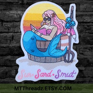 May include: An embroidered patch featuring a mermaid with pink hair, sunglasses, and a seashell top reading a book inside a wooden barrel. A fishing pole with blue floats stands nearby against a yellow and orange sunset. Text reads: Sun, Sand, Smut.