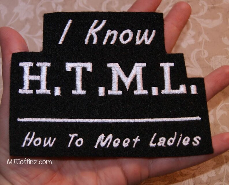 May include: Black felt patch with white embroidered text that reads "I Know H.T.M.L. How To Meet Ladies" and the website "MTCoffinz.com".