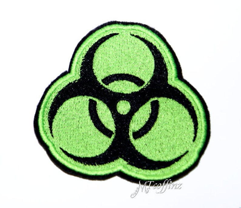May include: Green and black biohazard symbol patch. The symbol is a stylised triangle with three circles and a black outline.