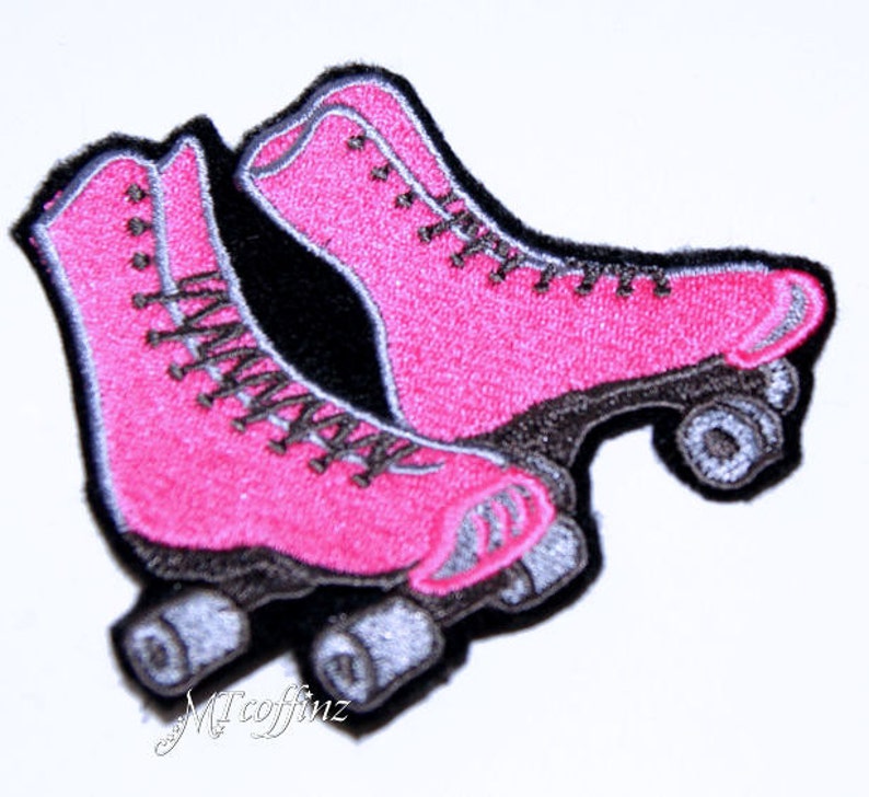 May include: Pink roller skate patch with black and gray details. The patch is embroidered and has a vintage style.