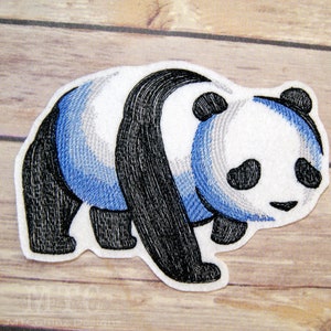 May include: Embroidered iron-on patch of a blue and black panda bear. The panda is walking and has a white face with black eyes and a black nose.