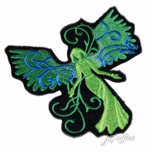 May include: Green and blue embroidered iron-on patch featuring a fairy with wings and floral details.