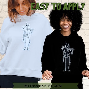 May include: Two people wearing hooded sweatshirts with a white outline of the Tin Man from The Wizard of Oz on the front. The text "EASY TO APPLY" is at the top of the image. The text "MTTThreadz.ETSY.COM" is at the bottom of the image.