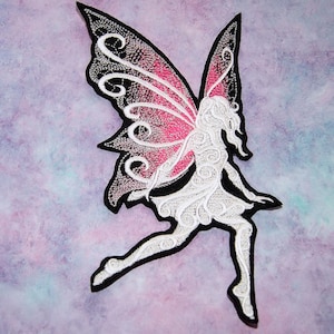 May include: White embroidered fairy with pink and black wings. The fairy is flying with her wings spread out. The fairy is a silhouette with intricate details.
