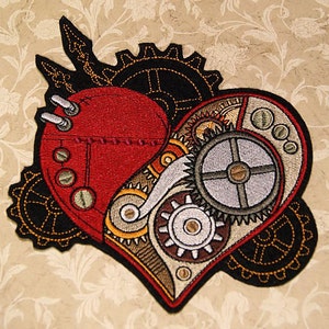 May include: Embroidered patch of a red heart with intricate gears and cogs inside, surrounded by black and gold gears. The heart is stitched with a red thread and has a steampunk aesthetic.