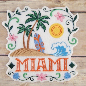 May include: Embroidered patch with a white background featuring a palm tree, a surfboard, a wave, a sun, and flowers. The text "MIAMI" is embroidered in orange with white outlines.