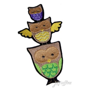 May include: An embroidered patch featuring three stacked owls. The top owl is purple, the middle owl is brown with yellow and green accents, and the bottom owl is brown with green accents.