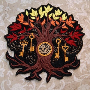 May include: Embroidered patch featuring a stylized tree with brown branches and a trunk, surrounded by golden keys and a clock face. The tree has red, orange, and yellow leaves.