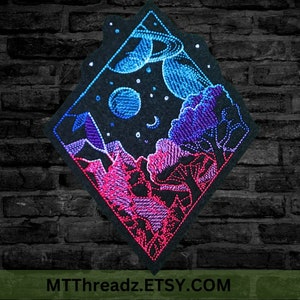 May include: Diamond-shaped embroidered patch depicting a night sky scene. The patch features a pink and purple mountain range, a forest of purple trees, and a blue planet with a ring system. The background is black with white stars.