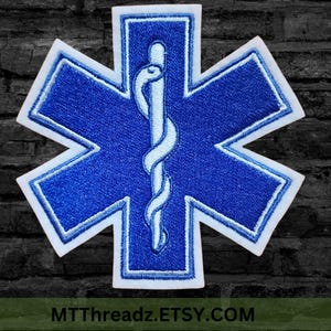 May include: Blue and white embroidered patch with a six-pointed star and a caduceus symbol in the center. The text "MTTThreadz.ETSY.COM" is at the bottom of the image.