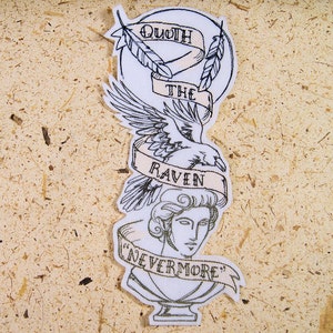May include: Embroidered patch featuring a raven, a bust, and banners with text. The banners read "Quoth the Raven" and "Nevermore." The design is primarily black and white with tan accents, set against a white background.