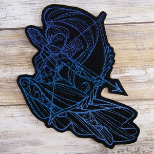 May include: A blue and black embroidered patch depicting a figure with a bow and arrow. The figure is in a dynamic pose, with the arrow pointed forward. The patch is made of felt and has a detailed design.