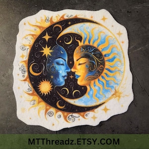 May include: A white felt patch with a colorful illustration of a sun and moon. The sun and moon are depicted as faces, with the sun being yellow and the moon being blue. The sun and moon are surrounded by stars and swirls.