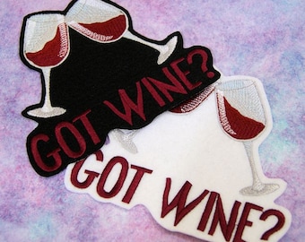 May include: Two embroidered iron-on patches with the text "GOT WINE?" and a design of two wine glasses clinking. One patch is black with white wine glasses and the other is white with silver wine glasses.