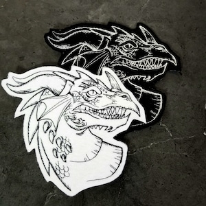 May include: Two embroidered dragon heads, one black and one white, with detailed scales and sharp teeth. The white dragon has a more detailed design with a textured neck.