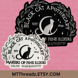 May include: Two black and white embroidered patches with the text "Black Cat Apothecary" and "Makers of Fine Elixirs Salem Massachusetts" and a black cat silhouette on a crescent moon.