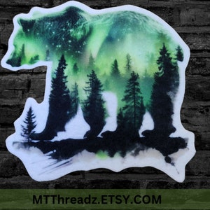 May include: A green and white watercolor sticker of a bear silhouette with a forest scene inside. The bear is walking and the forest is filled with pine trees. The background is a dark green and white watercolor wash.